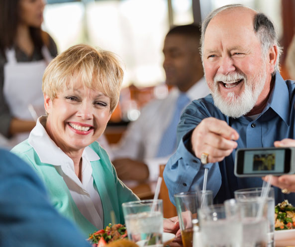 Laughing couple in community dining room.